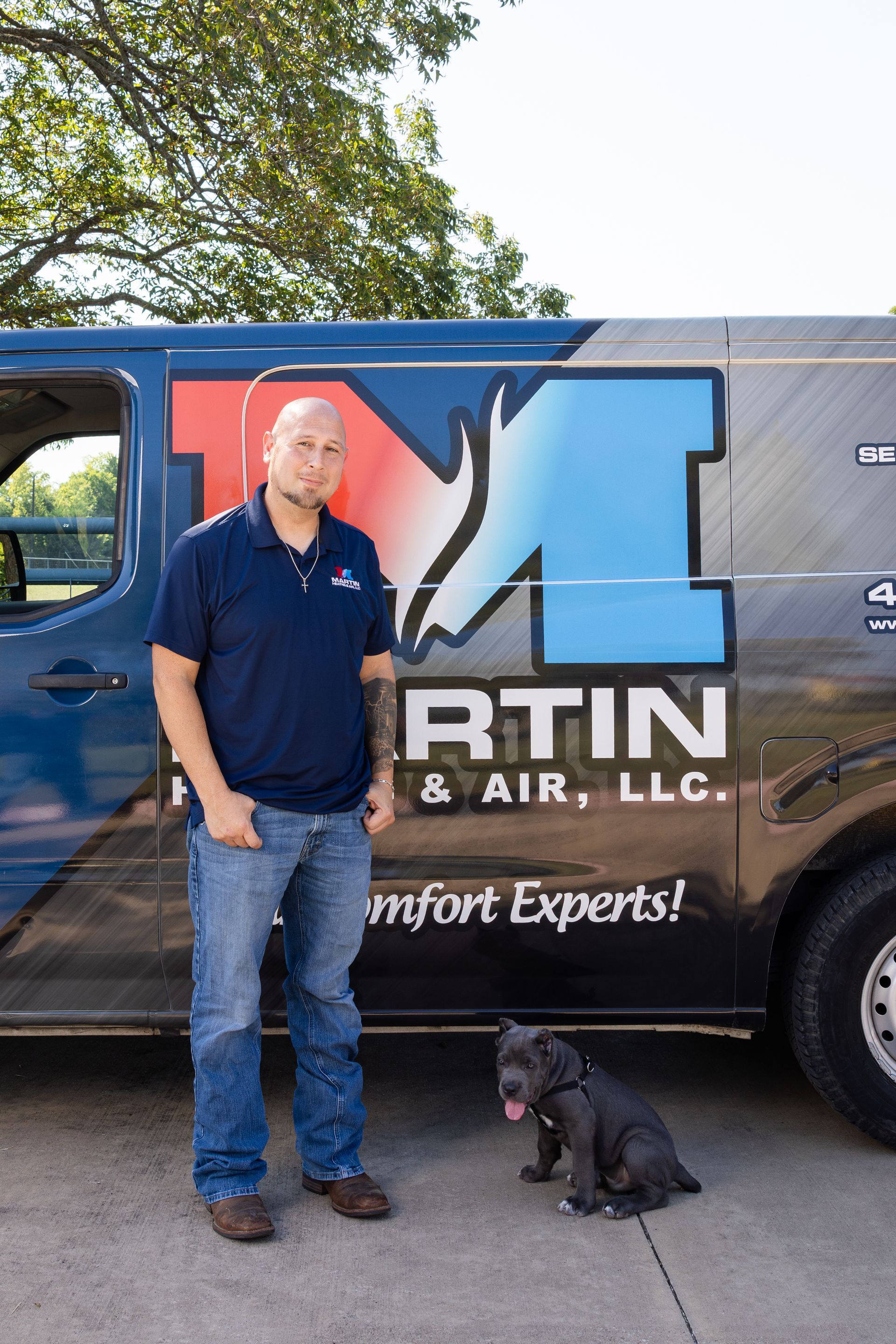 A family is sitting on a couch laughing together.