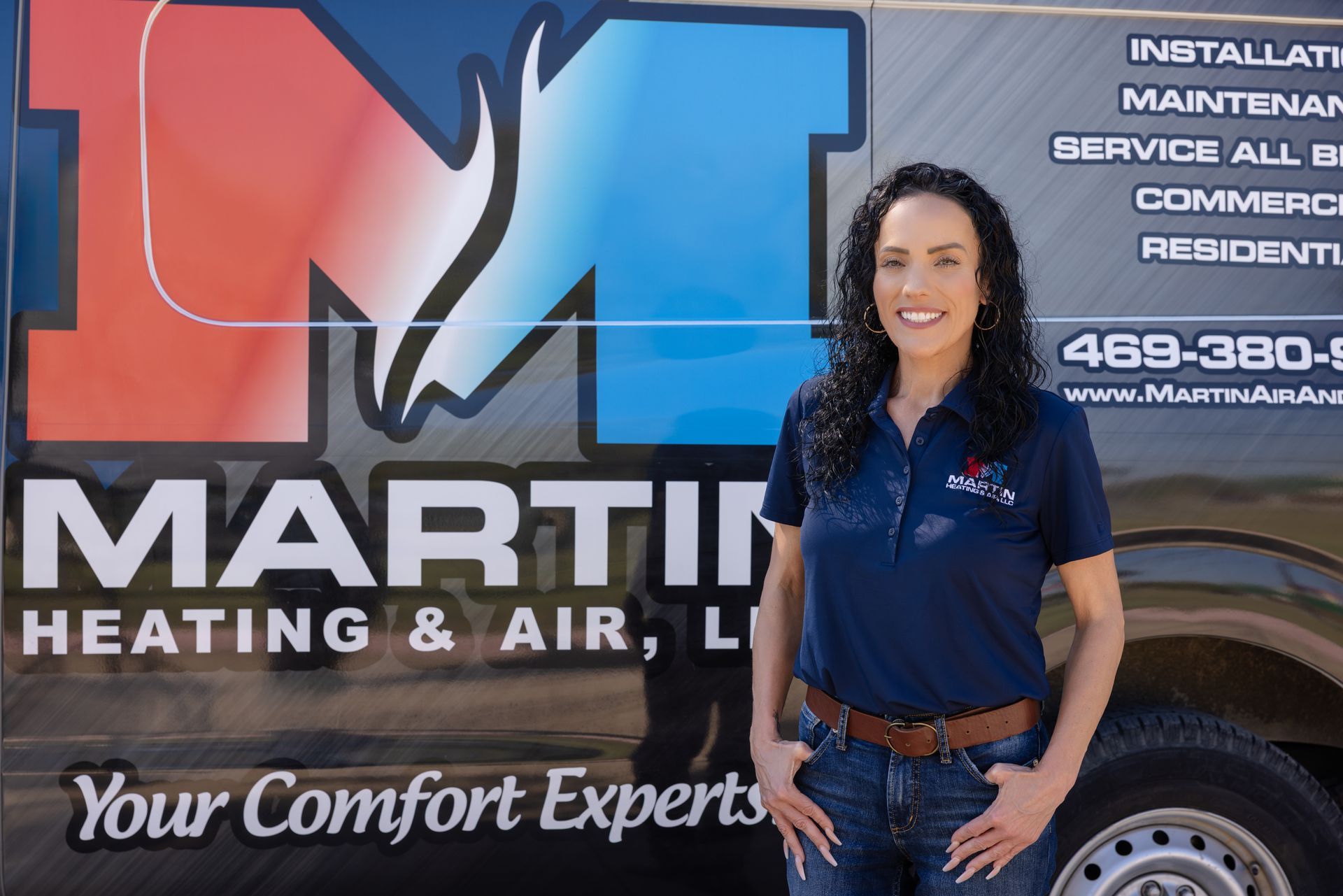 A family is sitting on the steps of their house.