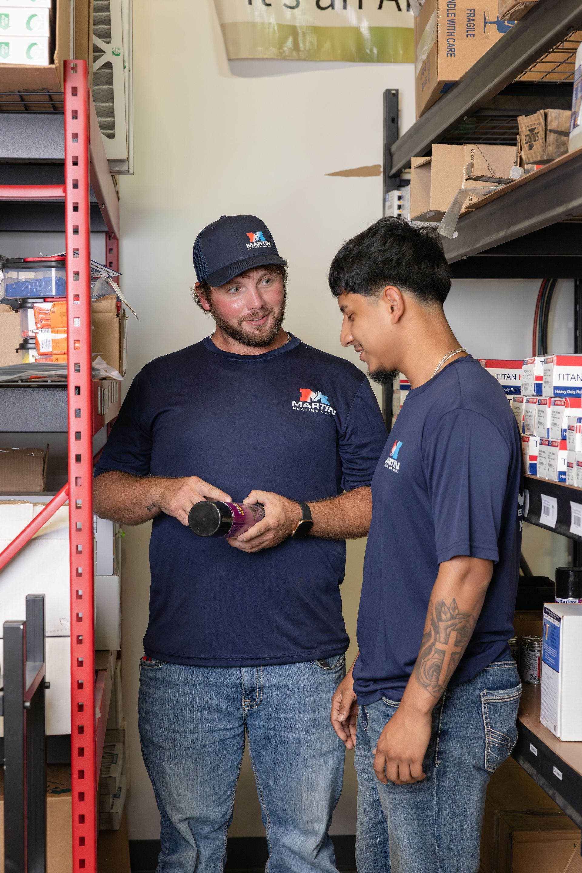 A woman is using a remote control to turn on the air conditioner.