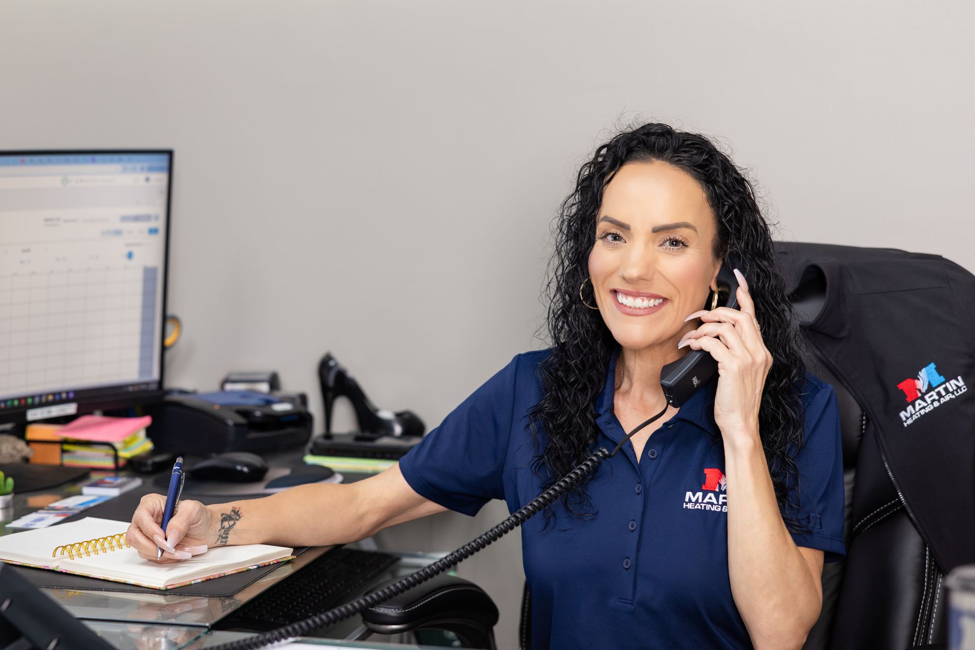 A man and a woman are sitting on a couch looking at a tablet.