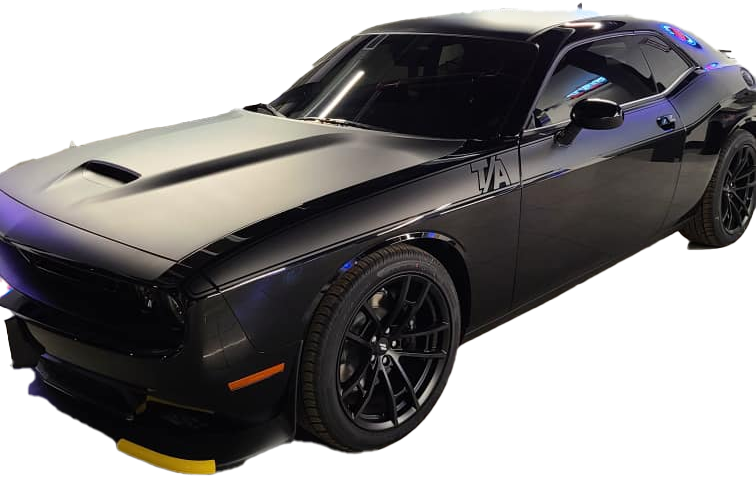 A black dodge challenger is sitting on a white background.