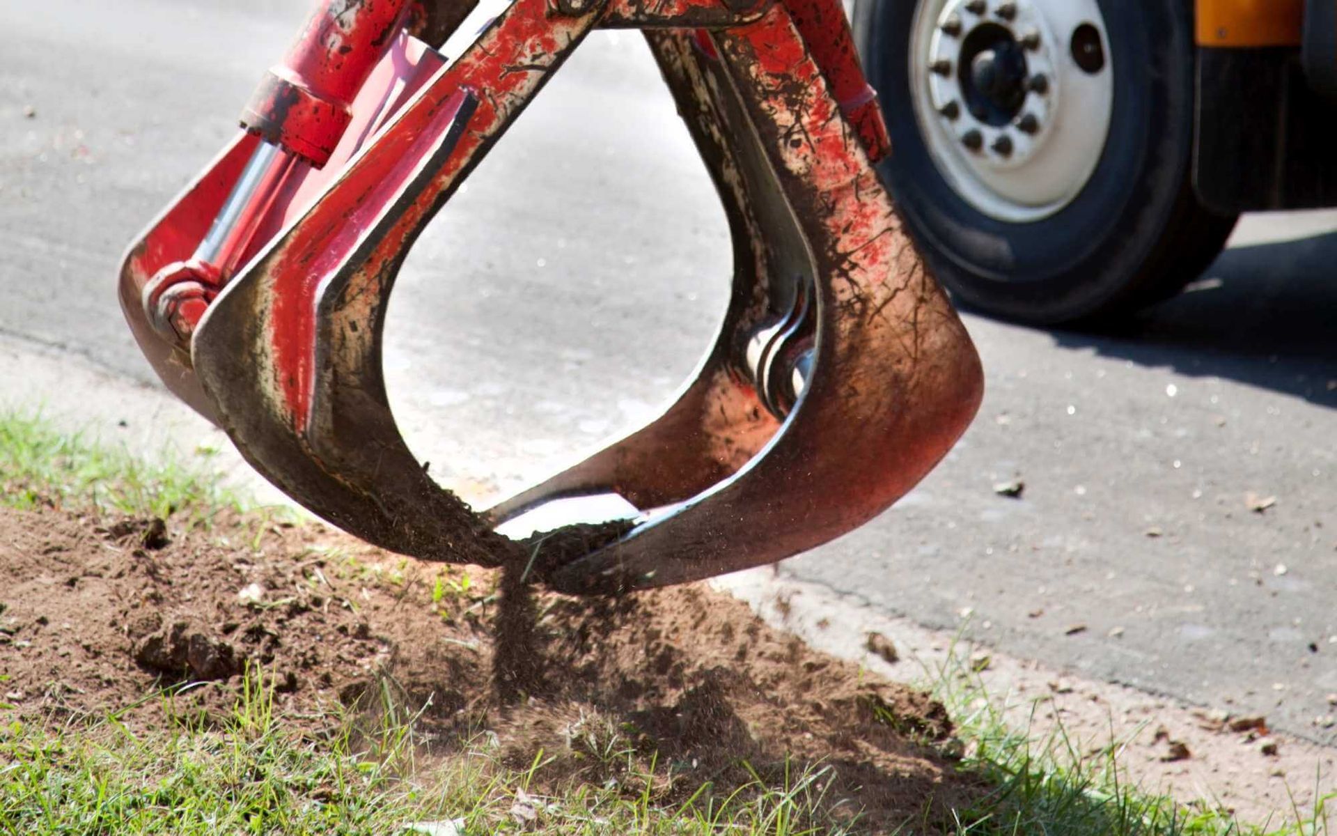 a tree stump is being removed from a South Floridian residence's front yard