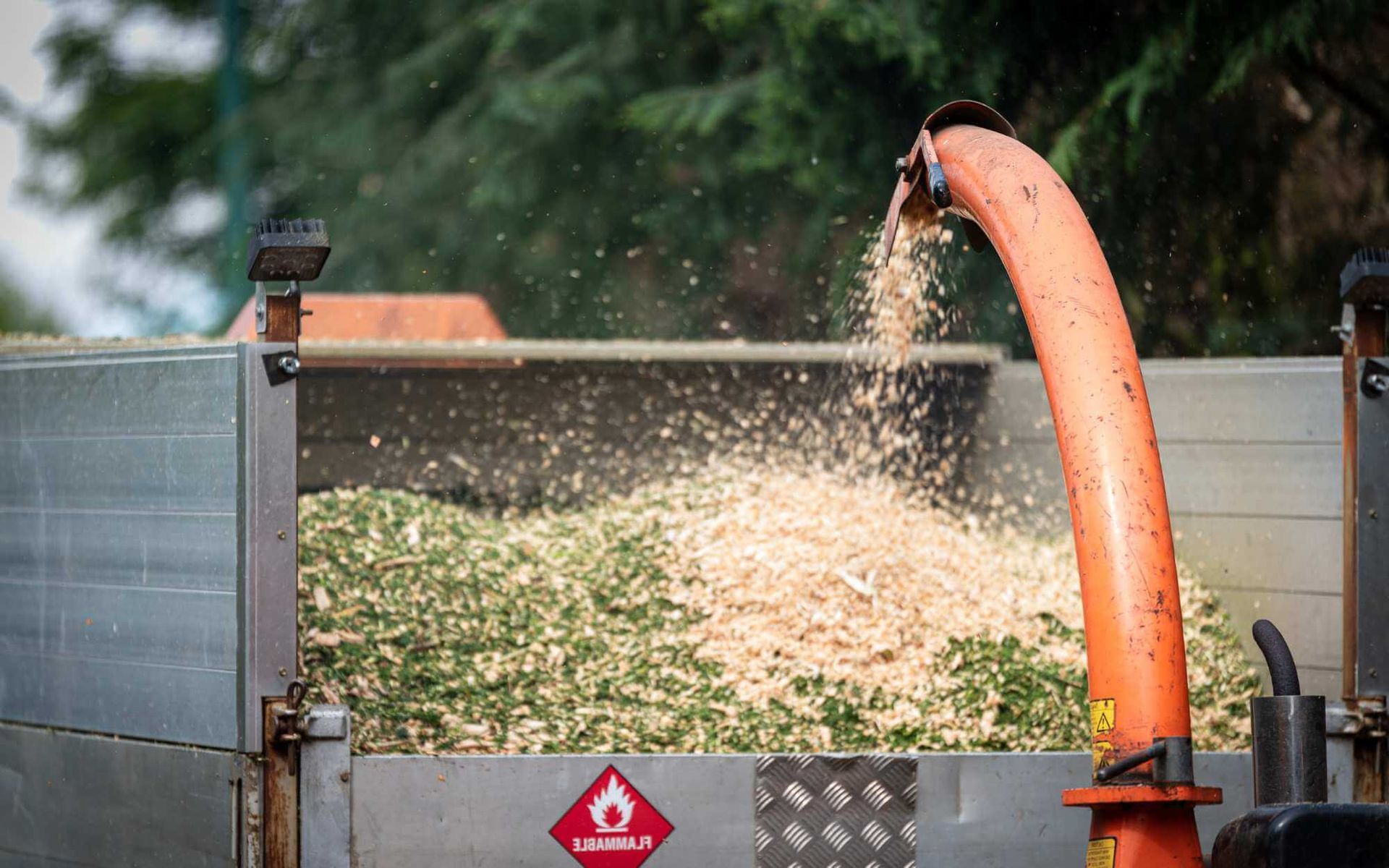 a wood chipper is used to reduce the tree stumps and debris fast