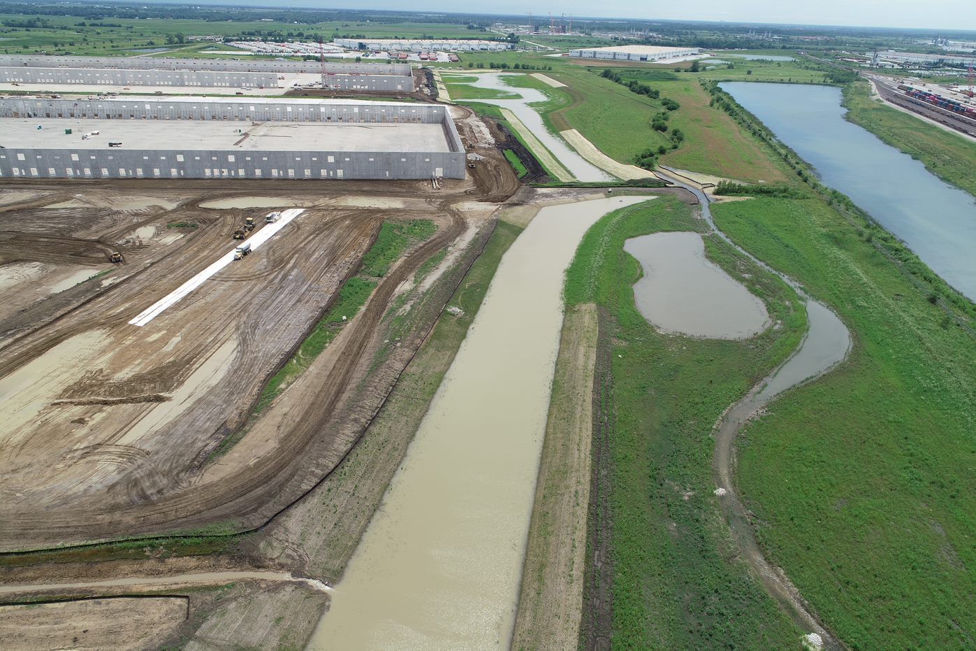 An aerial view of a construction site with a river running through it