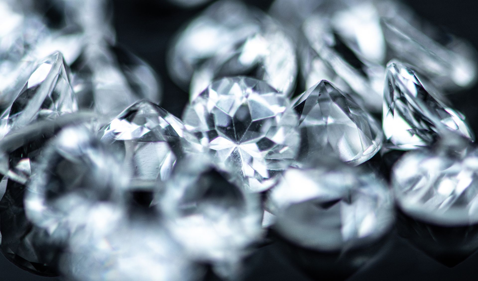 Close-up of small diamonds on black, highlighting cash for diamonds offers elegantly.