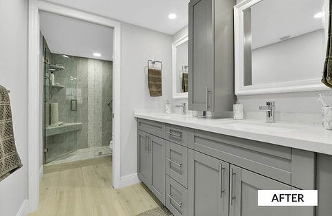 Gray bathroom renovation; double vanity, large mirror, tall cabinet, walk-in shower.