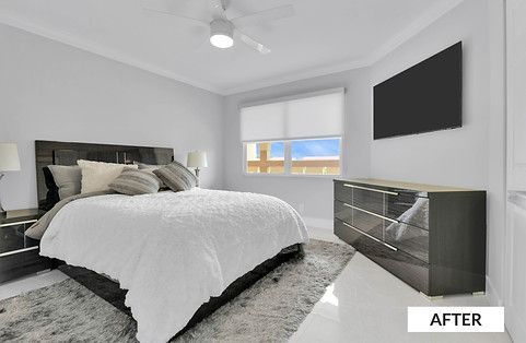 Bedroom with bed, dresser, TV, and window; white, gray, and black color scheme.