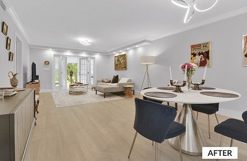 Living room after renovation, with dining table, sofa, and artwork on the walls.