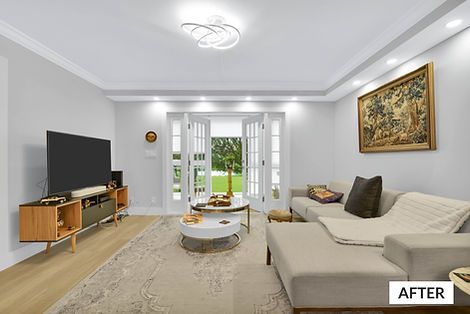 Living room with light gray walls, sectional sofa, and a TV; a doorway leads to a yard.