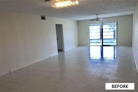 Empty living room with white tiled floor, sliding glass door, white walls, and a ceiling fan.