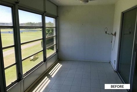 Sunroom with tiled floor and large windows overlooking a golf course. White walls, before renovation.