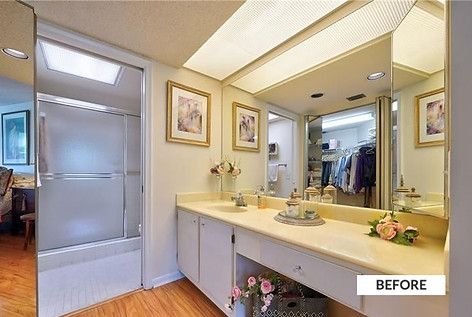 Bathroom with a vanity, large mirror, and a frosted glass shower door.