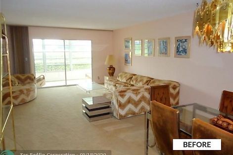 A living room with a patterned sofa, chairs, and a sliding glass door; the walls are pink.