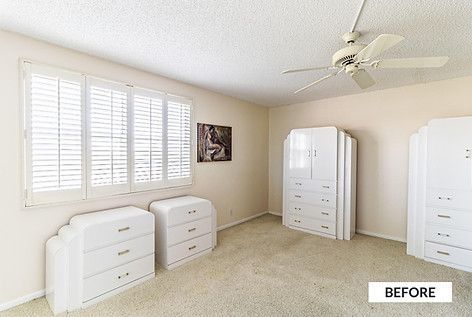 Bedroom with white furniture, carpet, and window shutters; ceiling fan.