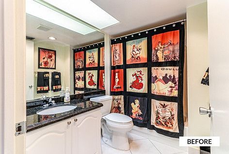 Bathroom with red and black curtain featuring vintage posters. White sink, toilet, cabinets, and granite countertop.