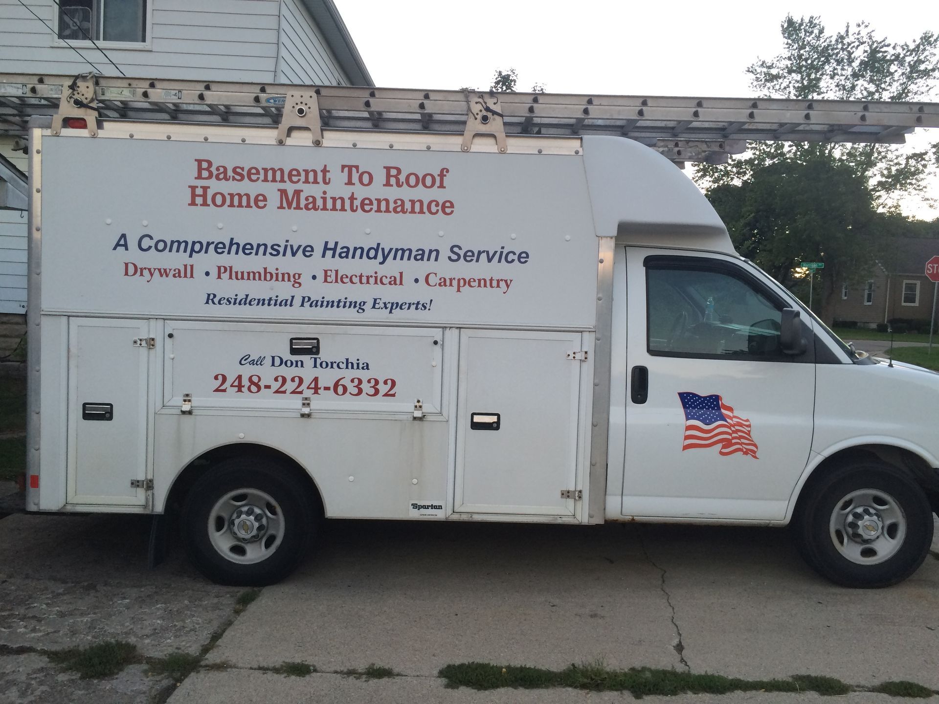 A white van that says basement to roof home maintenance