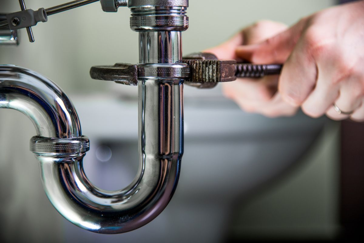 A Plumber Doing Repair Work On A Drain — Santa Maria, CA — Zeek's Plumbing