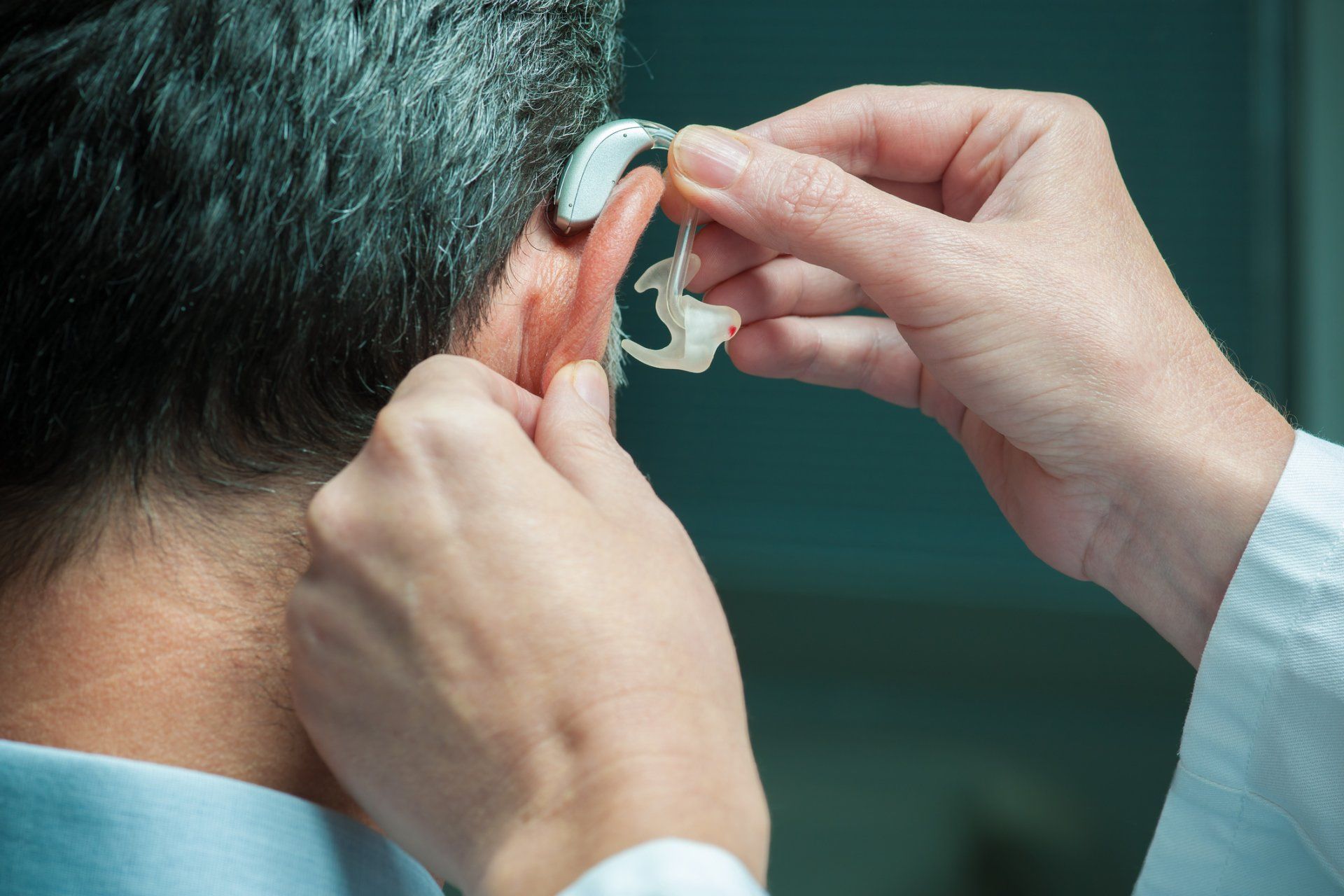 Hearing Aid Fitting - A Doctor Fitting The Hearing Aid Device To The Man in Summerville, SC