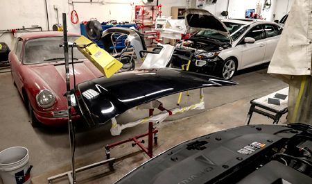 Two cars parked in separate garage bays.