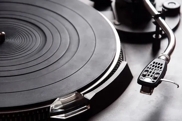 A close up of a record player playing a record