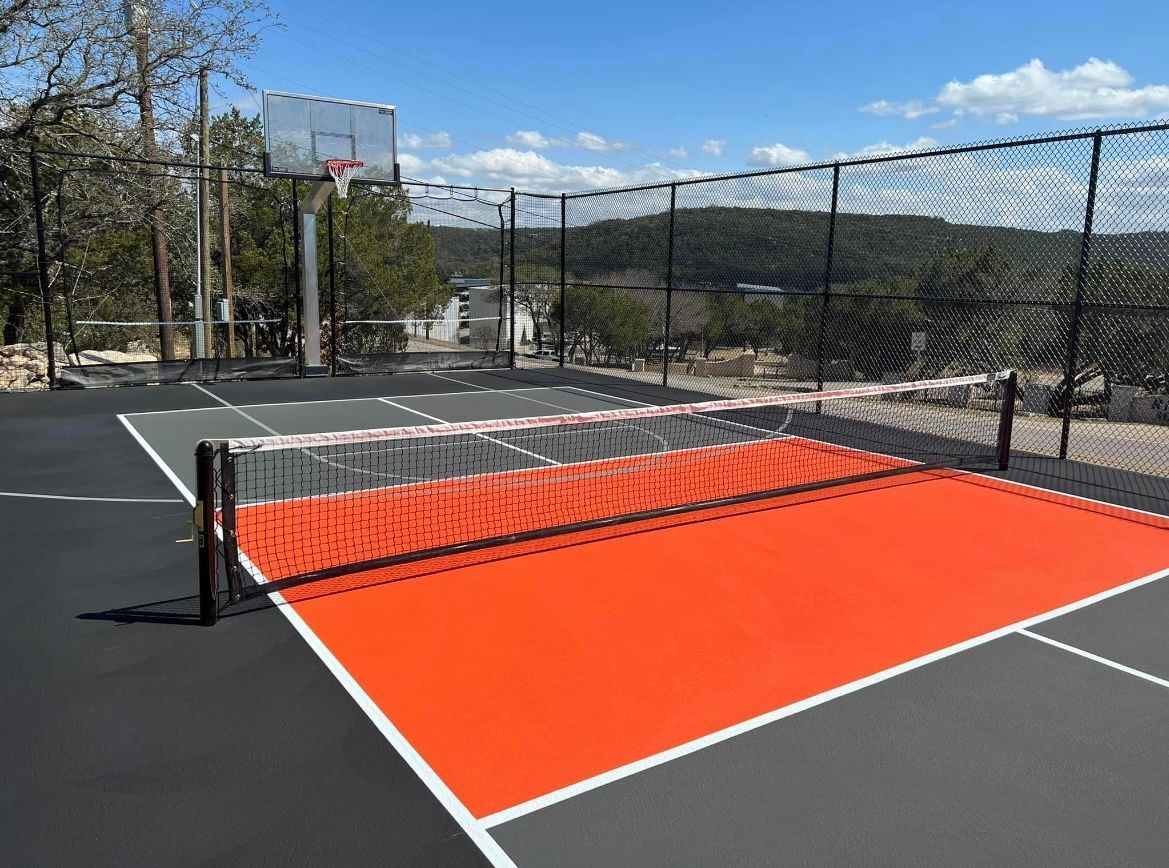 two women are giving each other a high five while playing paddle tennis