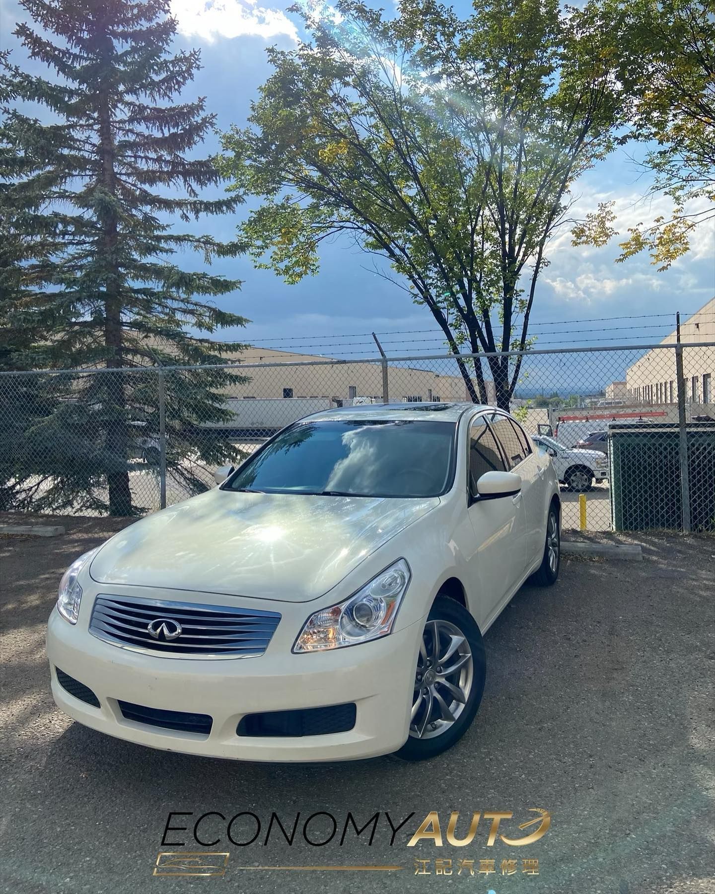 White Infiniti G37 Sedan Parked Outdoors Near Trees | Economy Auto Repair