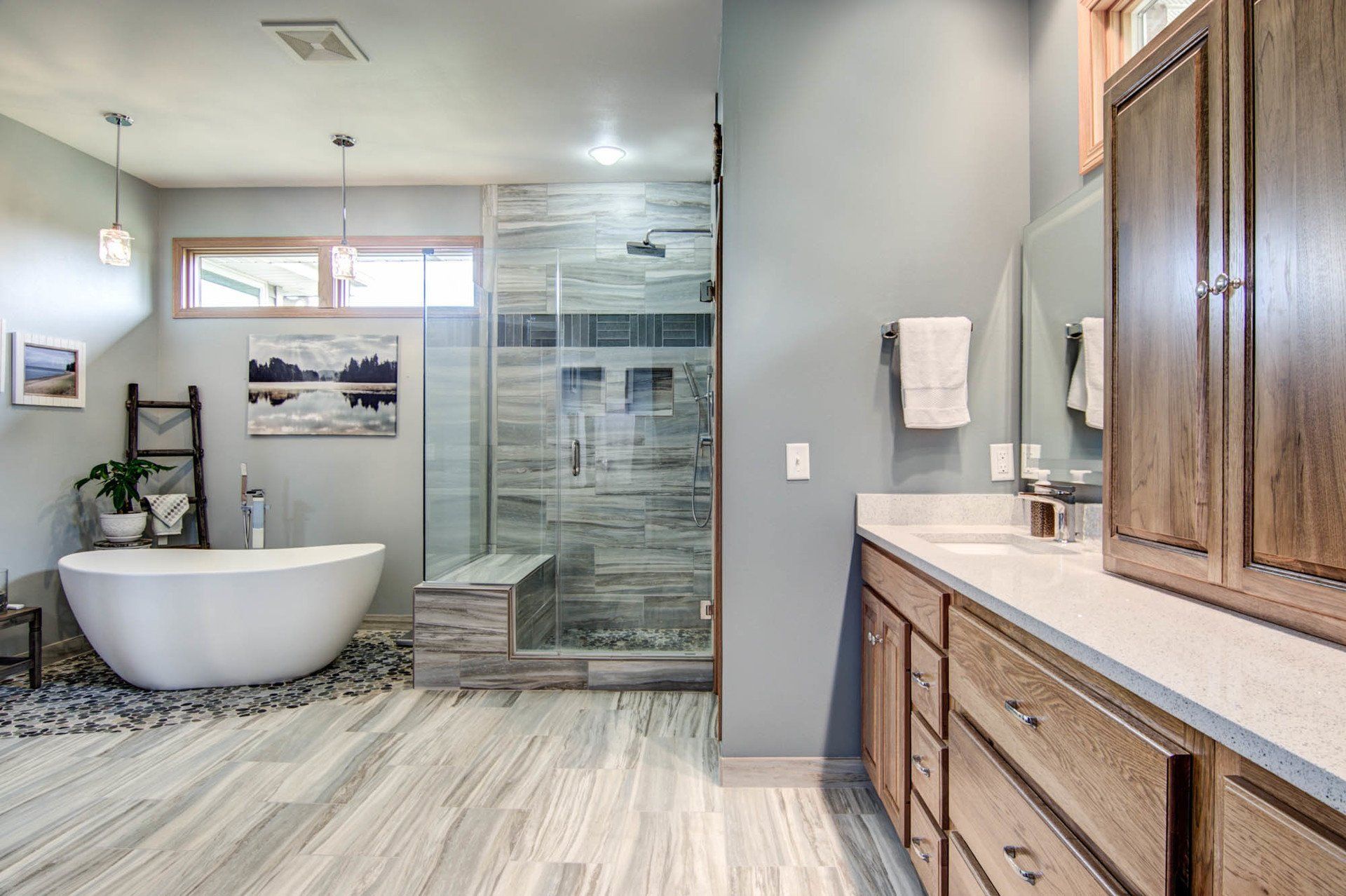 A bathroom with a bathtub , sink , and walk in shower.