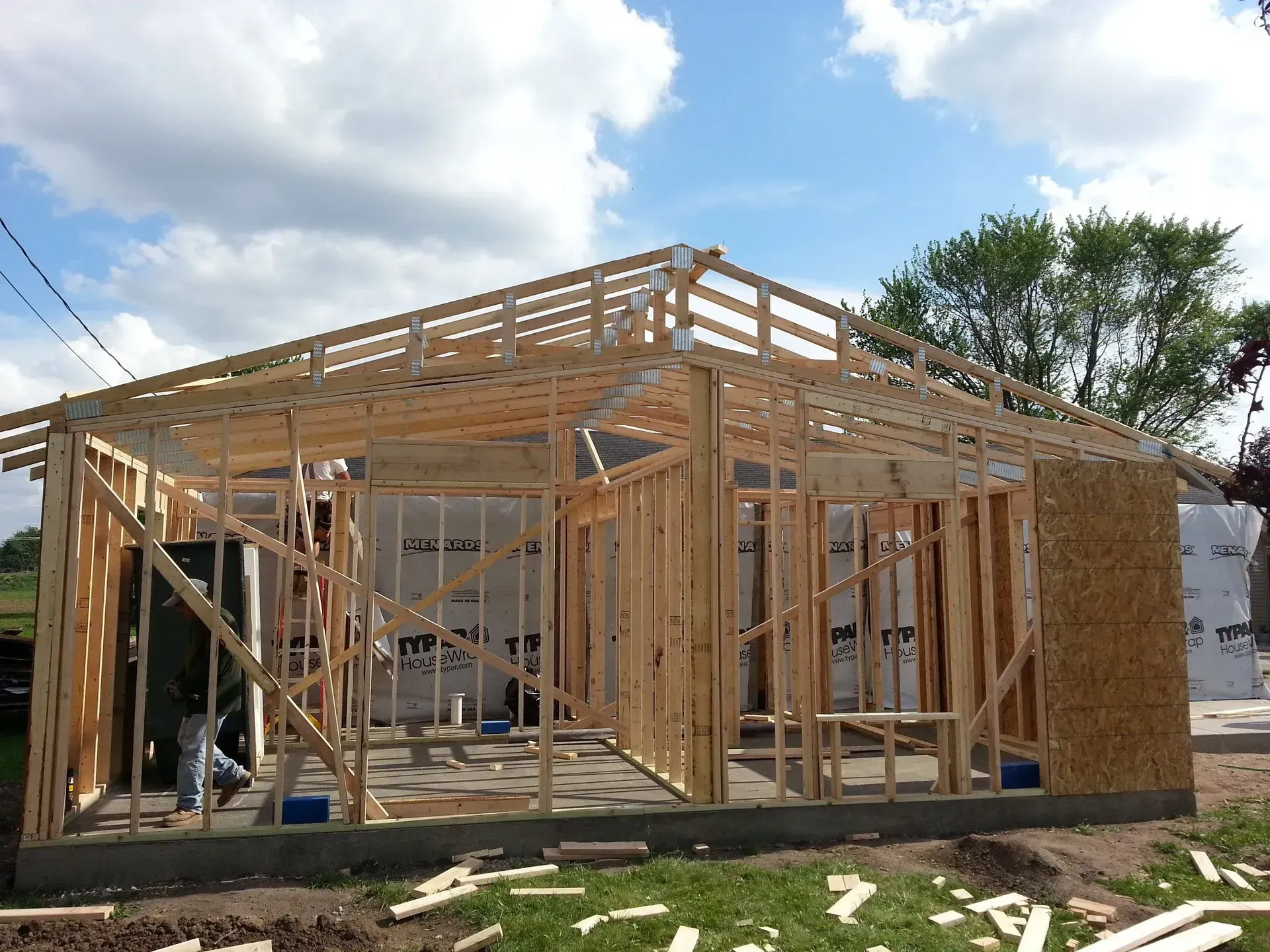 A house that is being built with a blue sky in the background