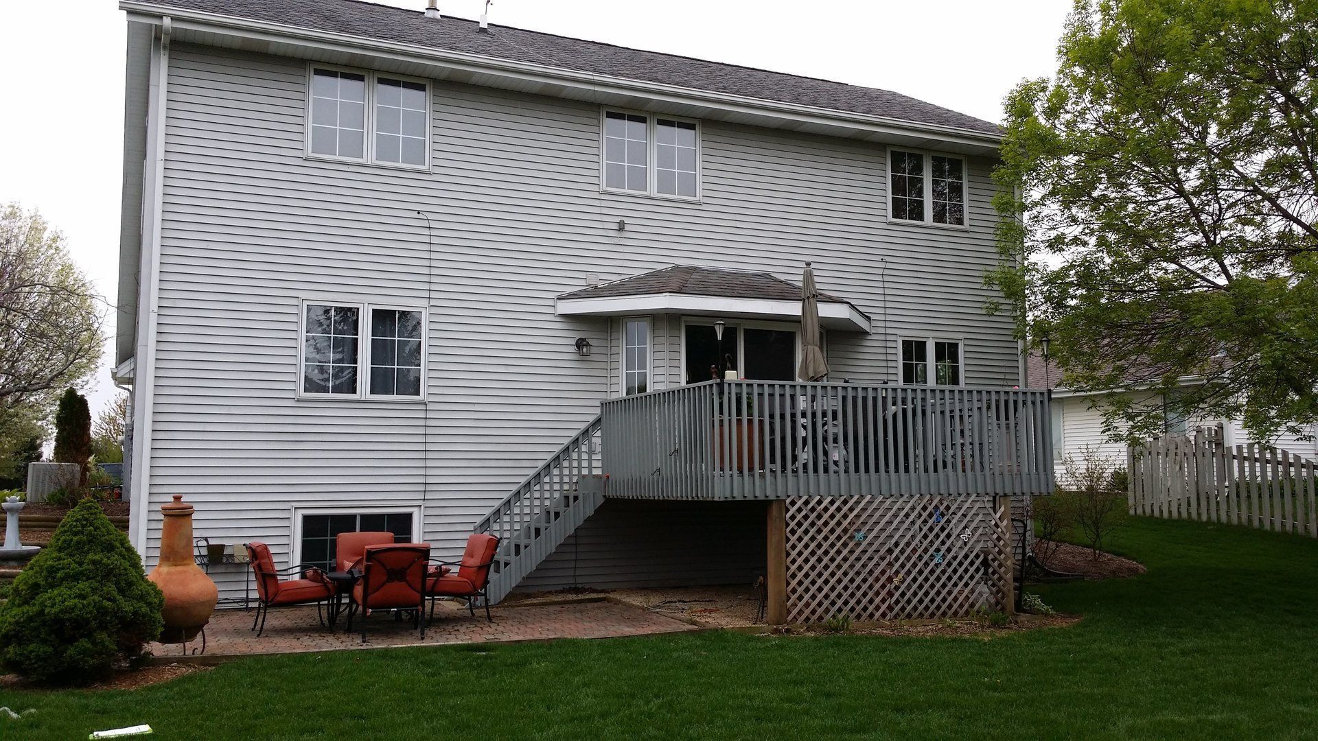 The back of a house with a large deck and stairs