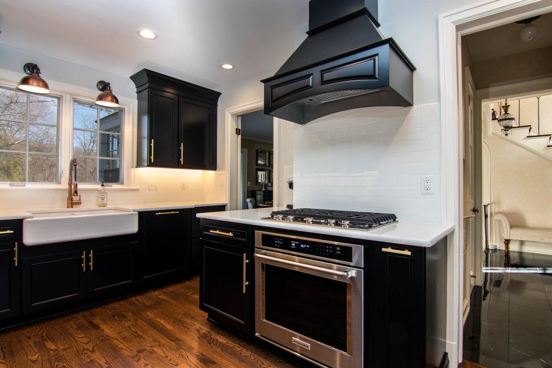 A kitchen with black cabinets and stainless steel appliances