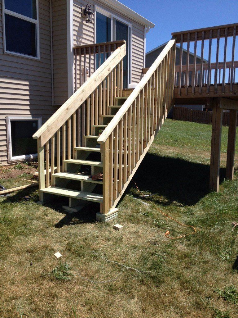 A wooden deck with stairs leading up to it