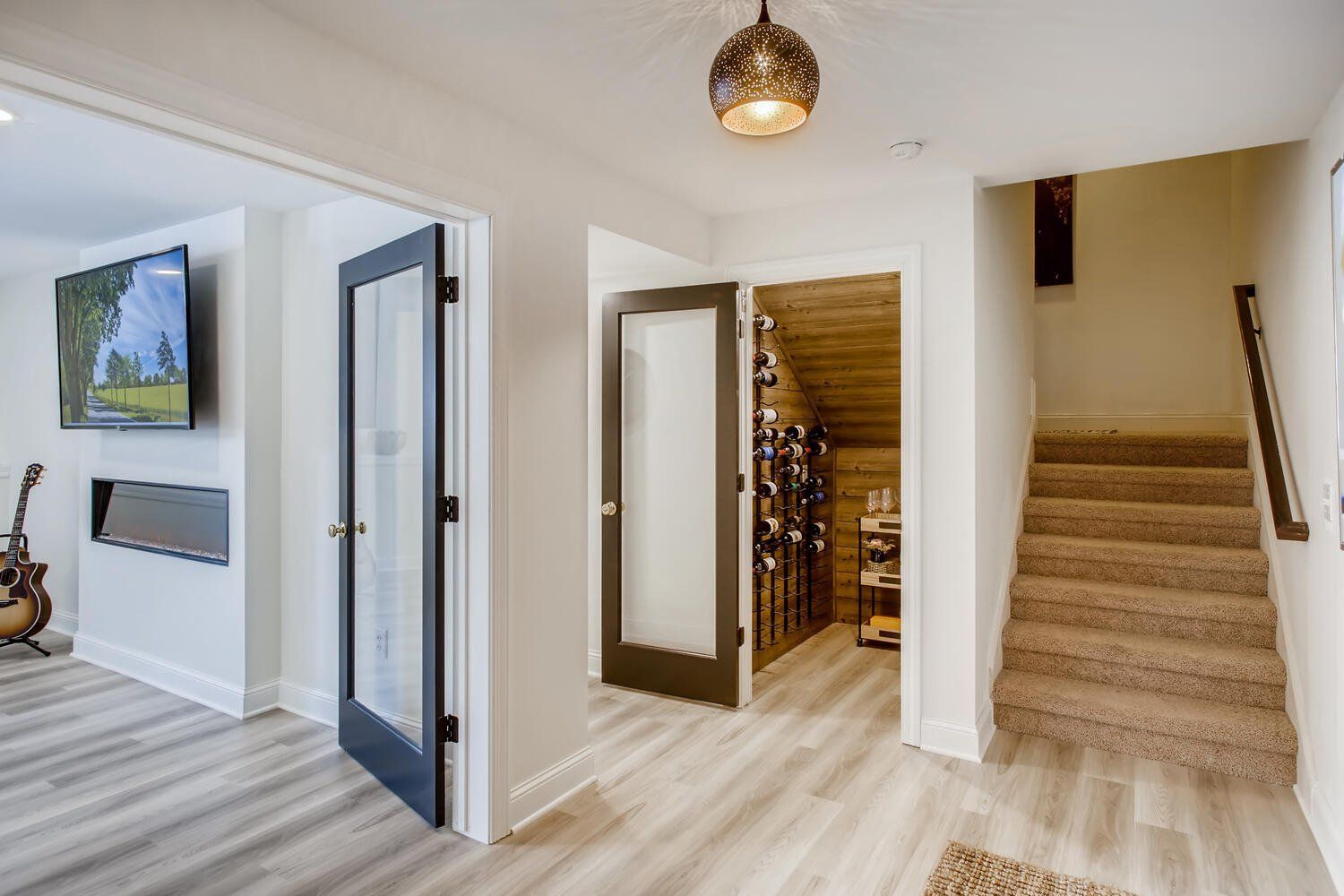A hallway with stairs leading up to the second floor of a house.