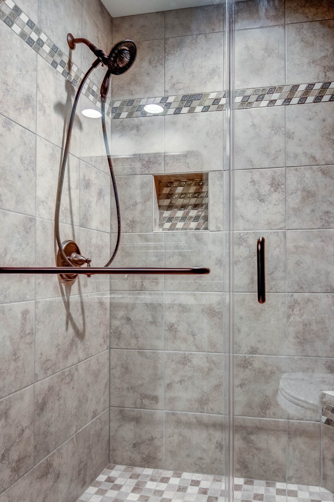 A bathroom with a walk in shower and a toilet.