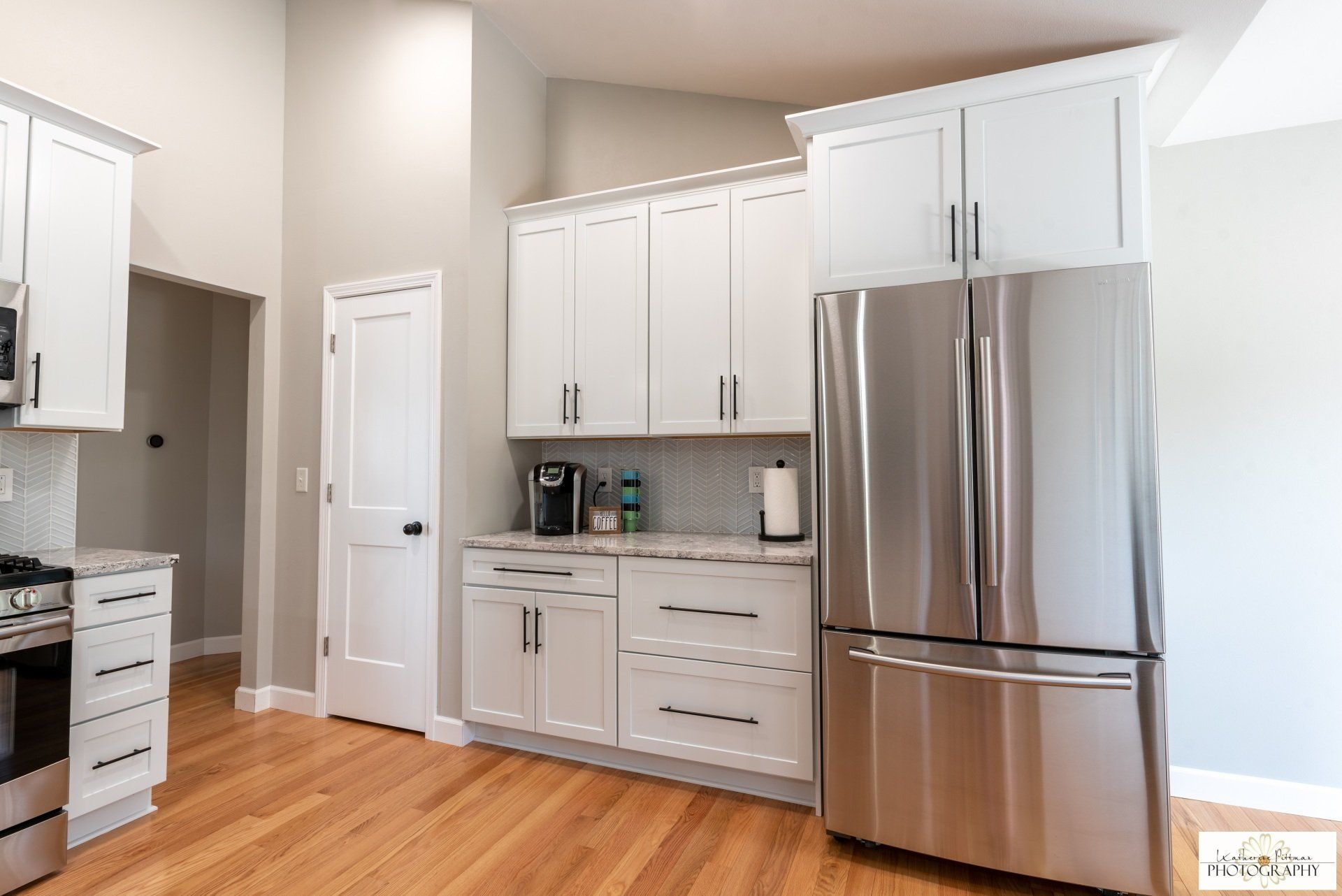 A kitchen with white cabinets and stainless steel appliances.