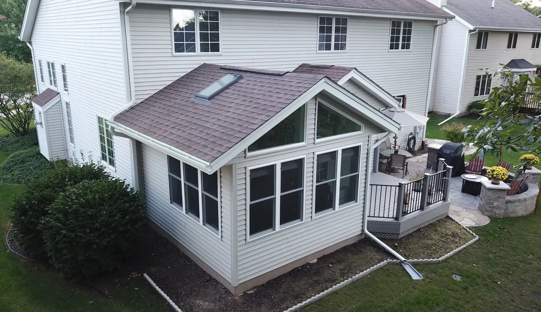 An aerial view of a house with a screened in porch.