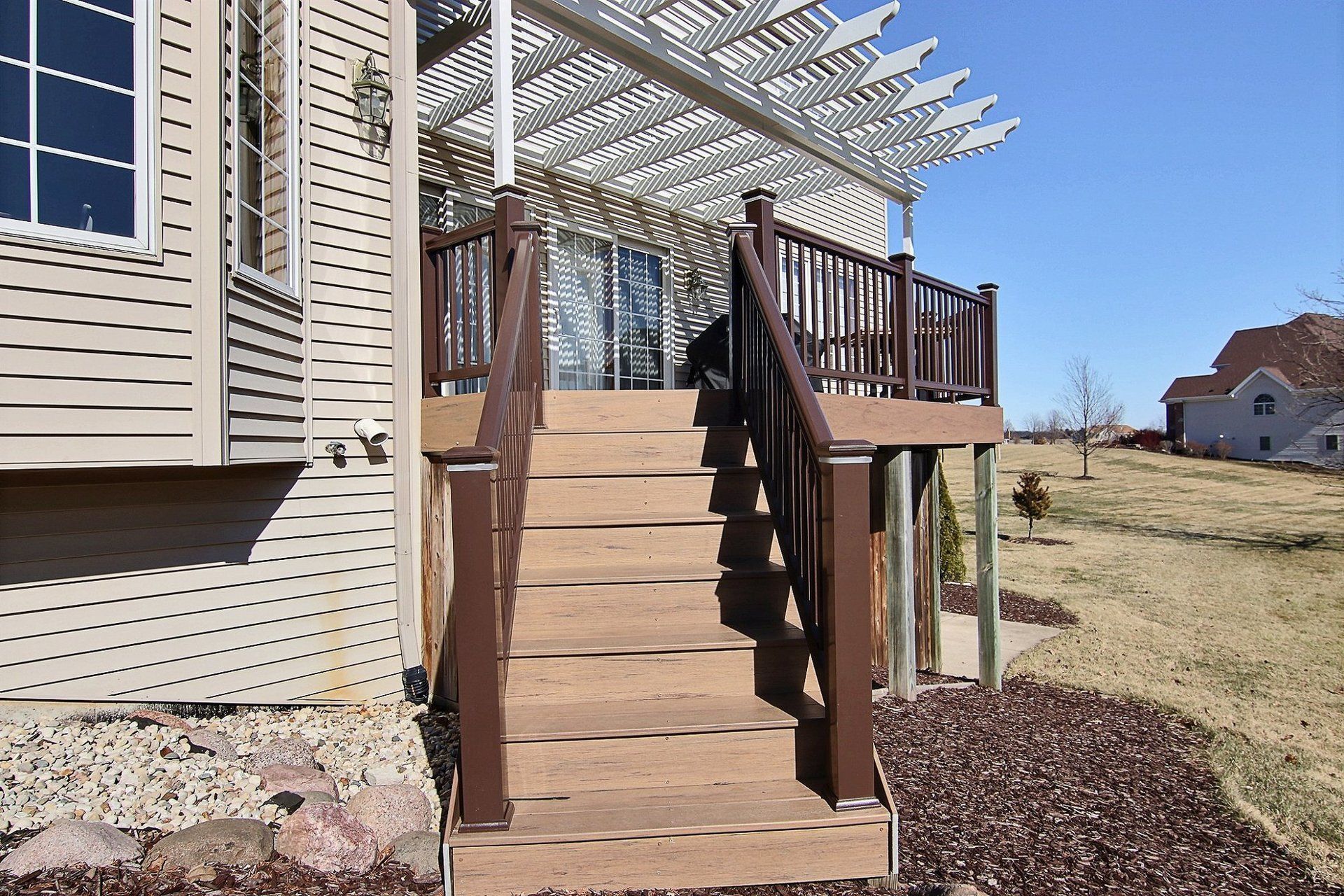 A wooden deck with stairs leading up to it