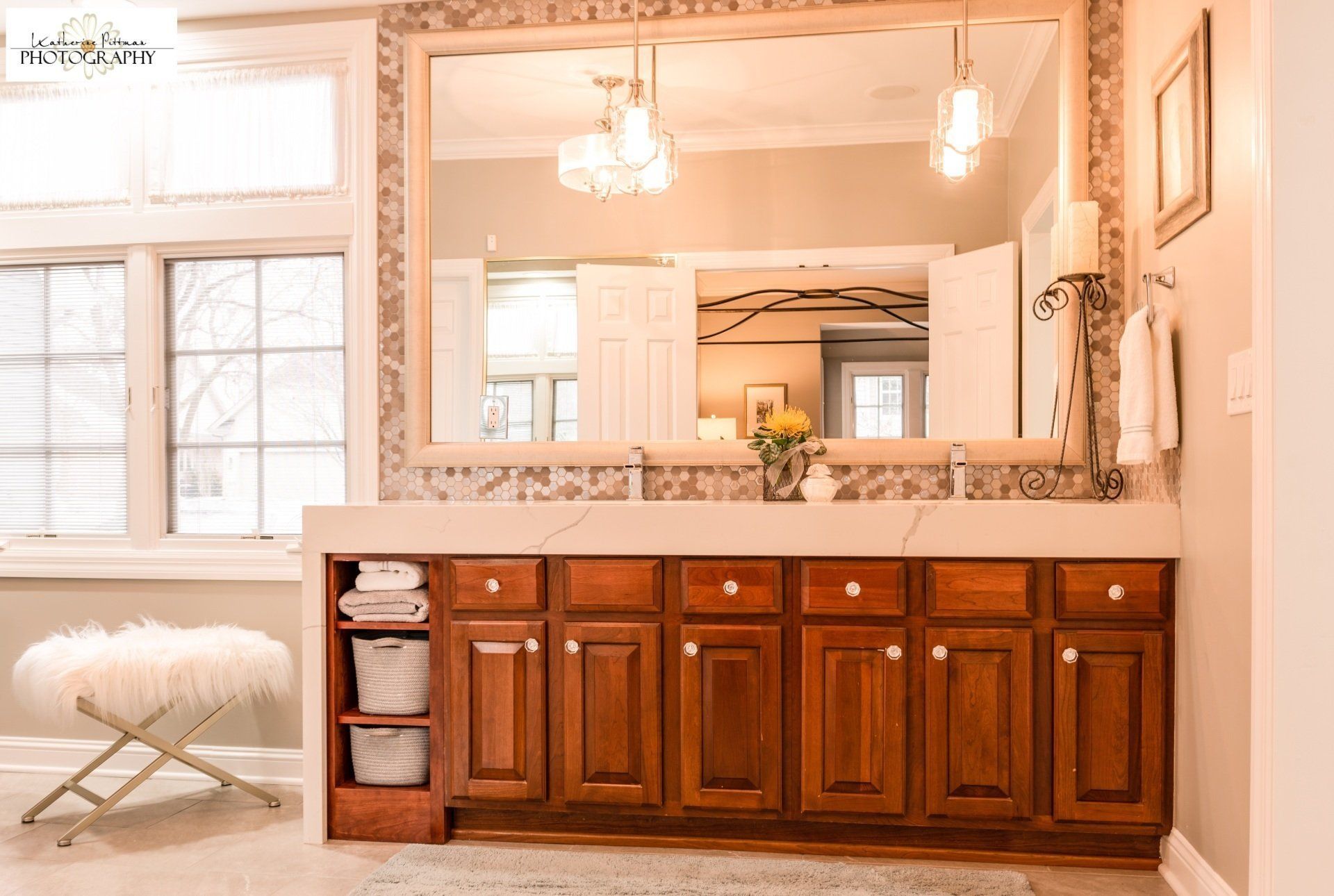 A bathroom with two sinks and a large mirror.