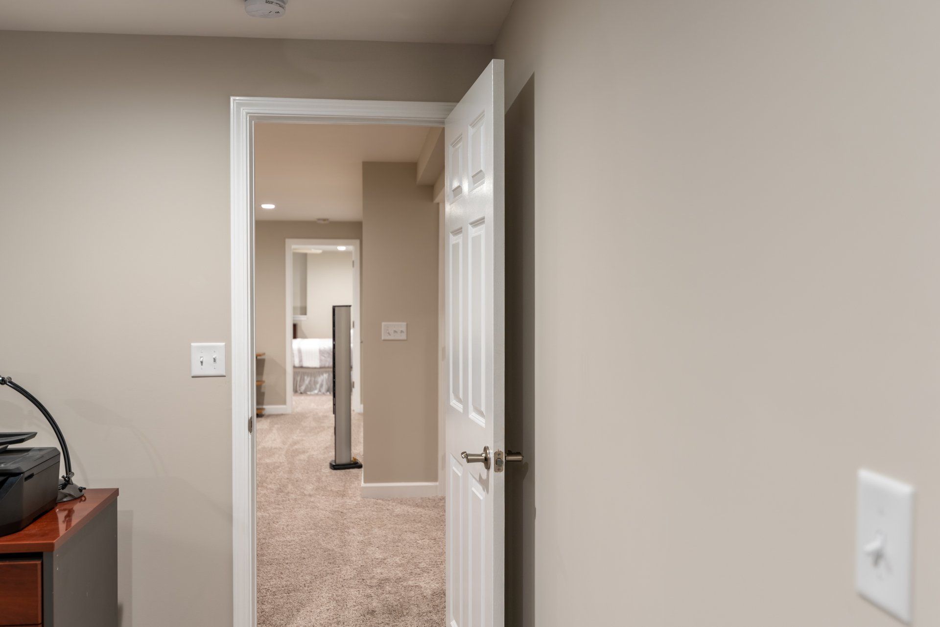 A room with a door open leading to a basement.