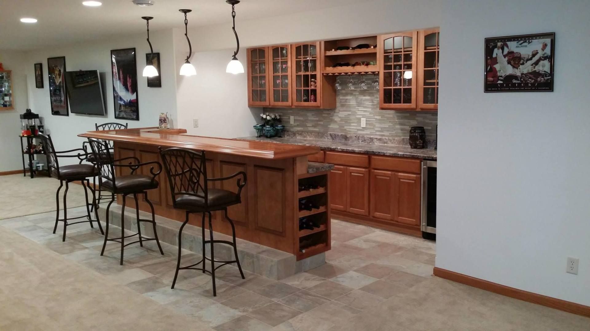 A kitchen with a bar and stools in it