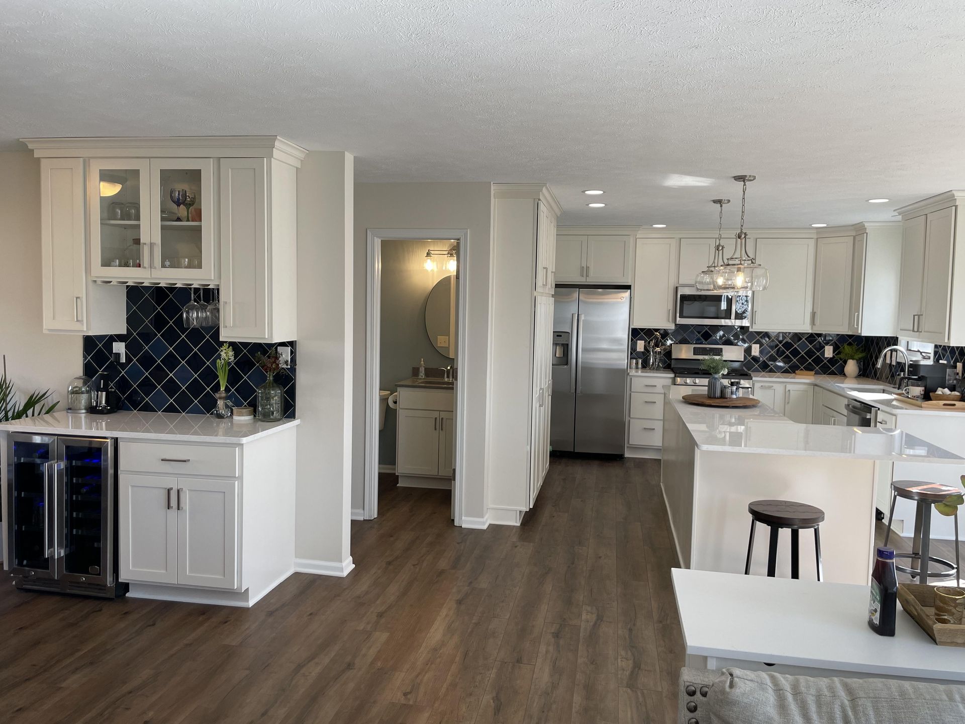 A kitchen with white cabinets and stainless steel appliances.