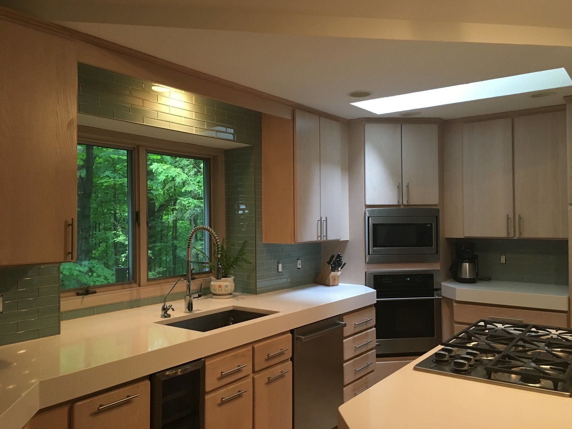 A kitchen with stainless steel appliances and wooden cabinets