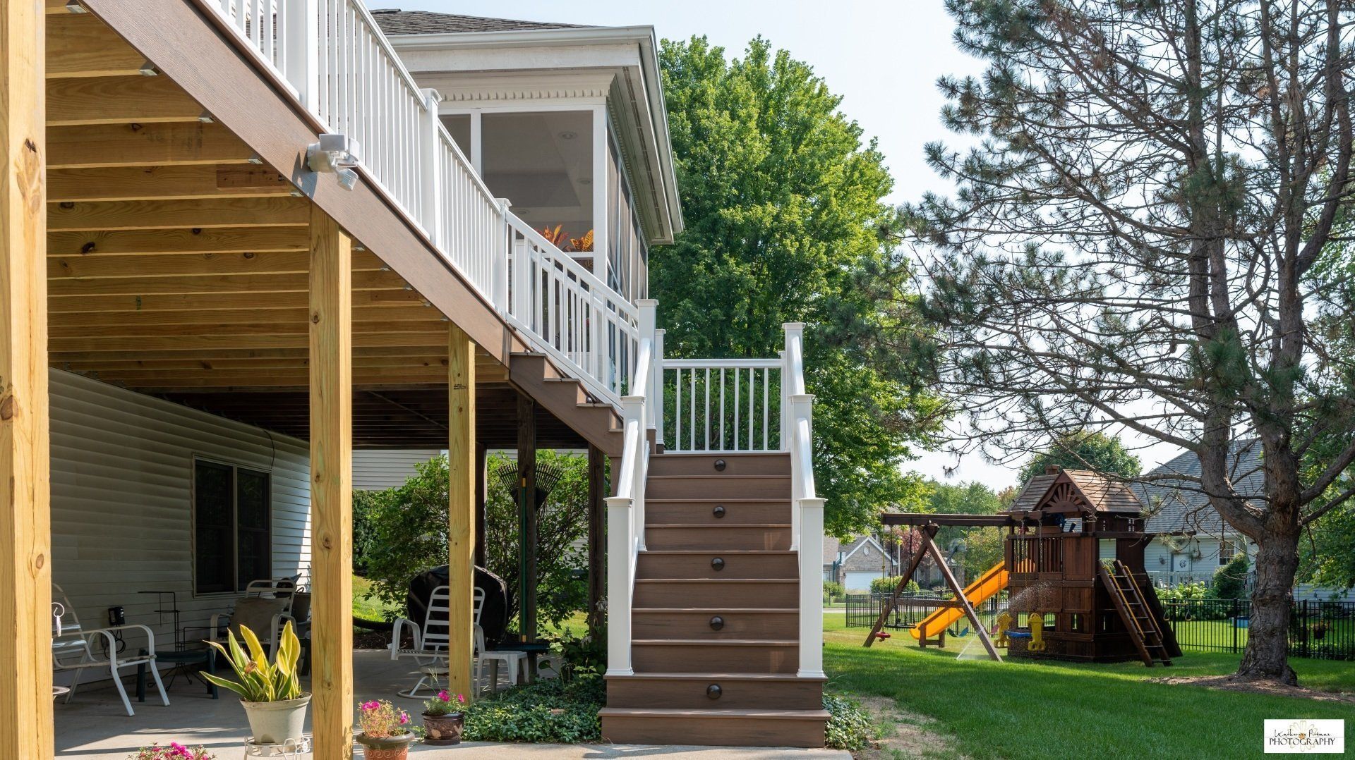 A house with a screened in porch and stairs
