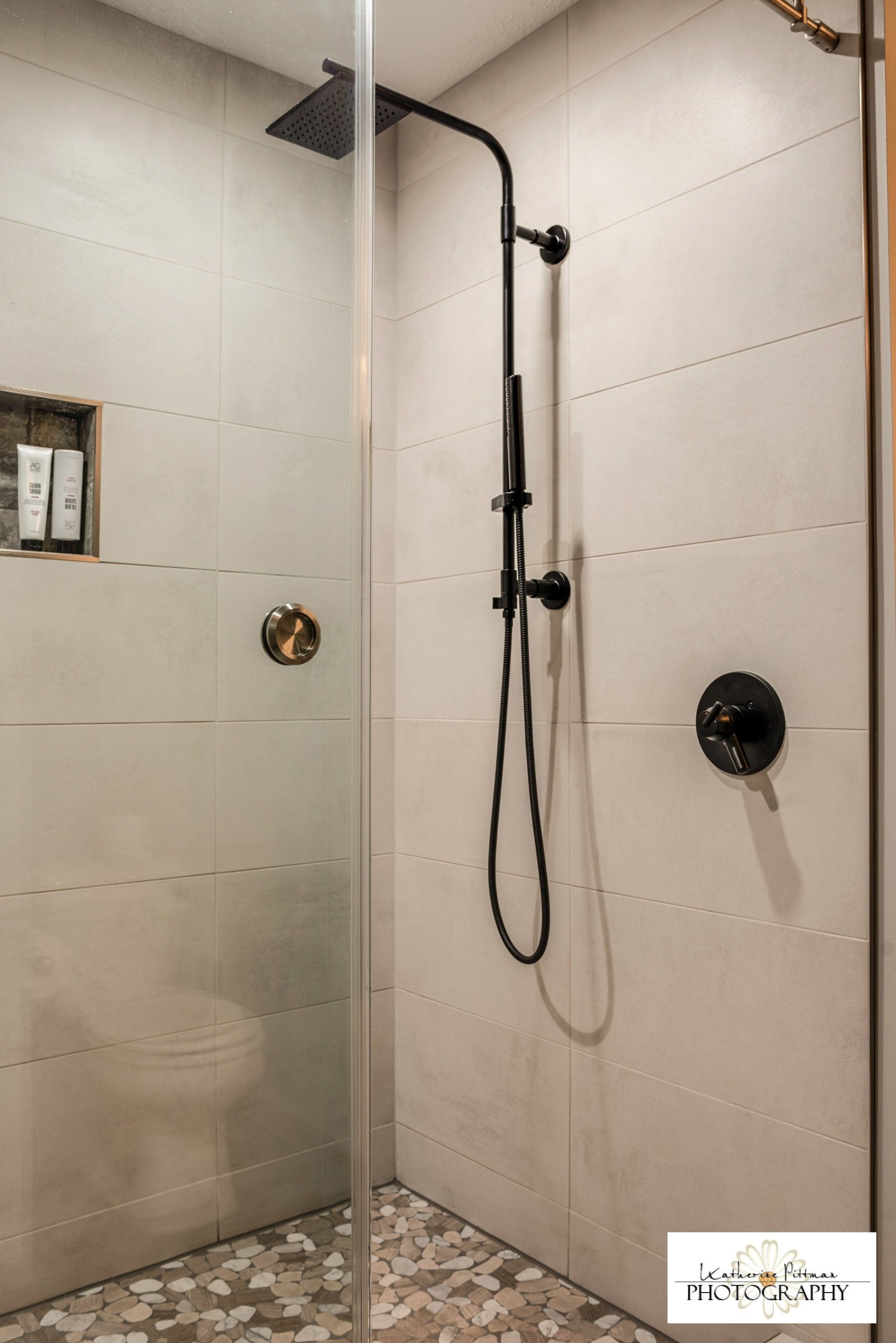 A bathroom with a walk in shower and a toilet.