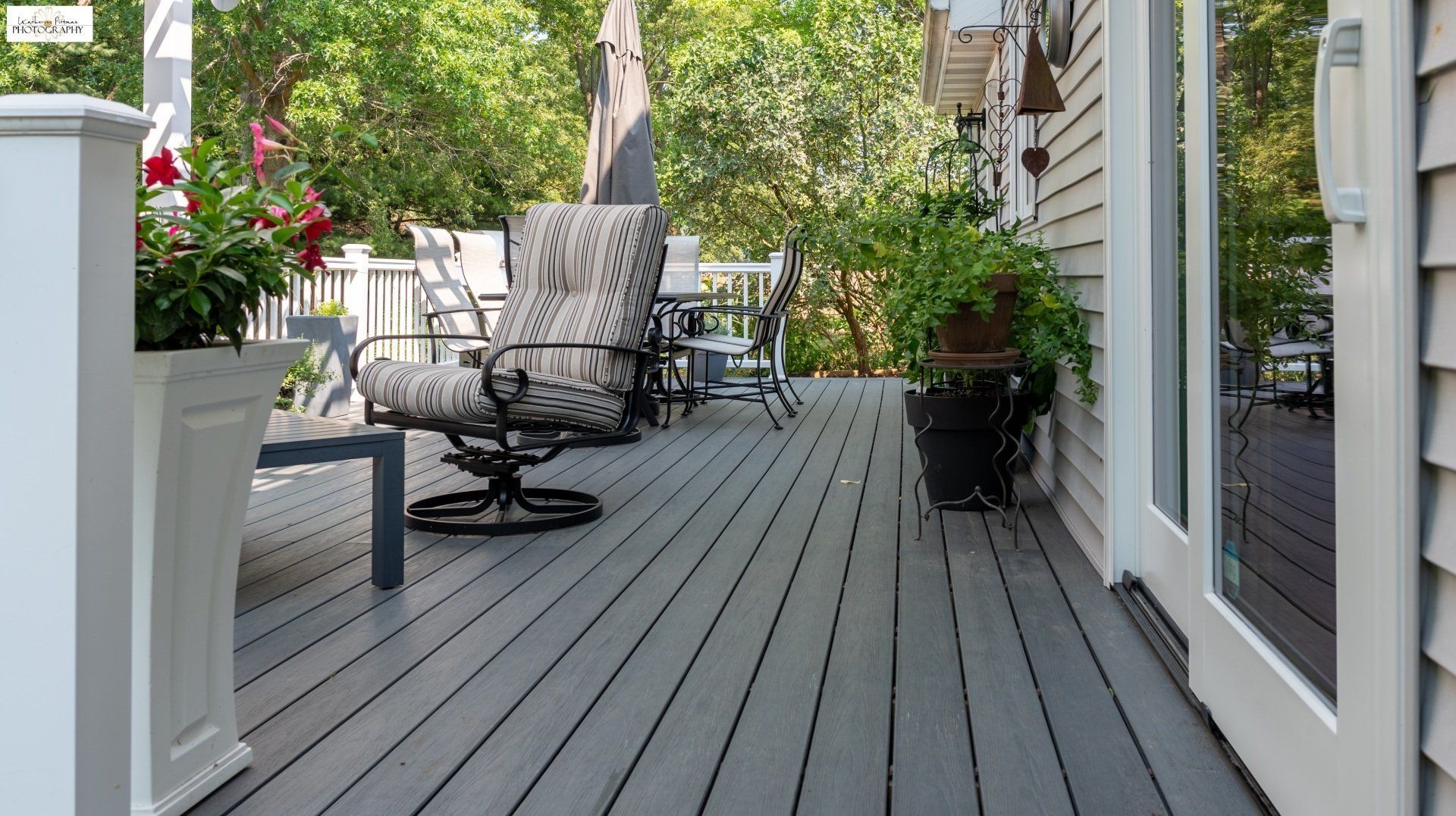 A deck with a chair and a table on it