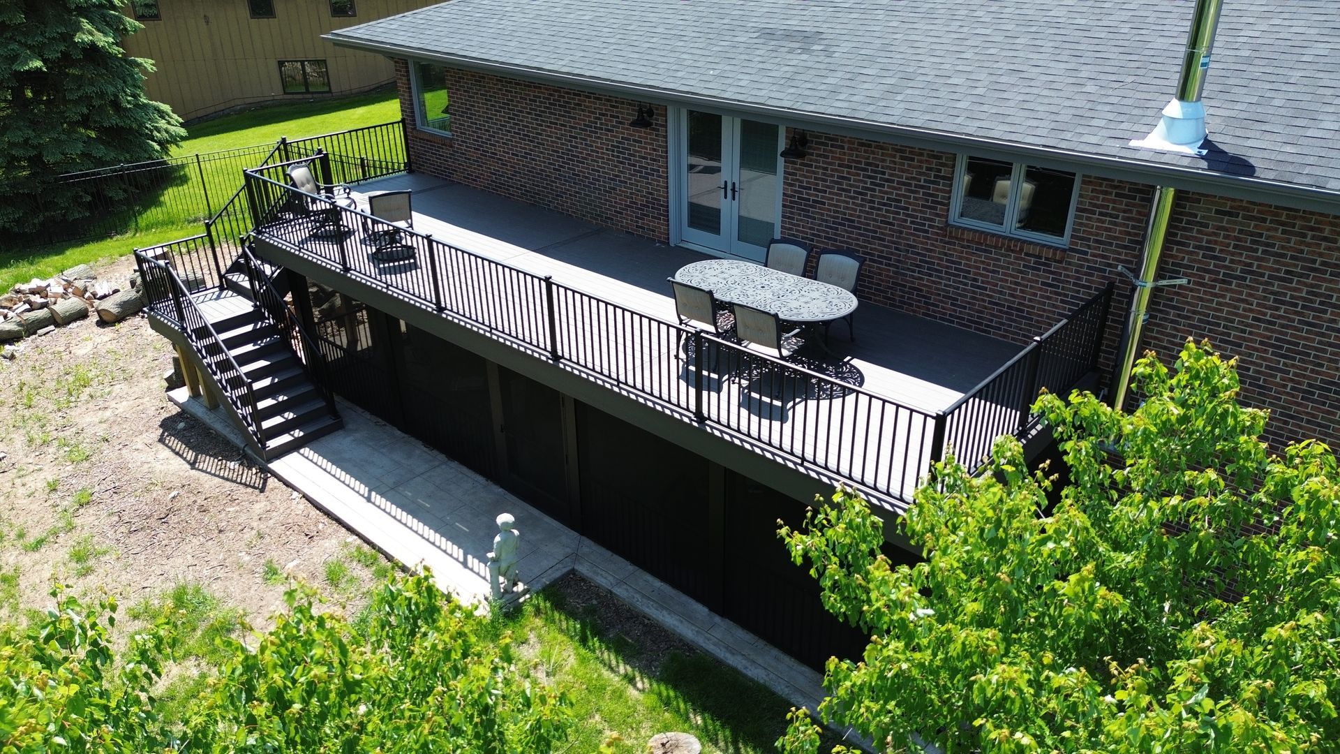 An aerial view of a house with a large deck