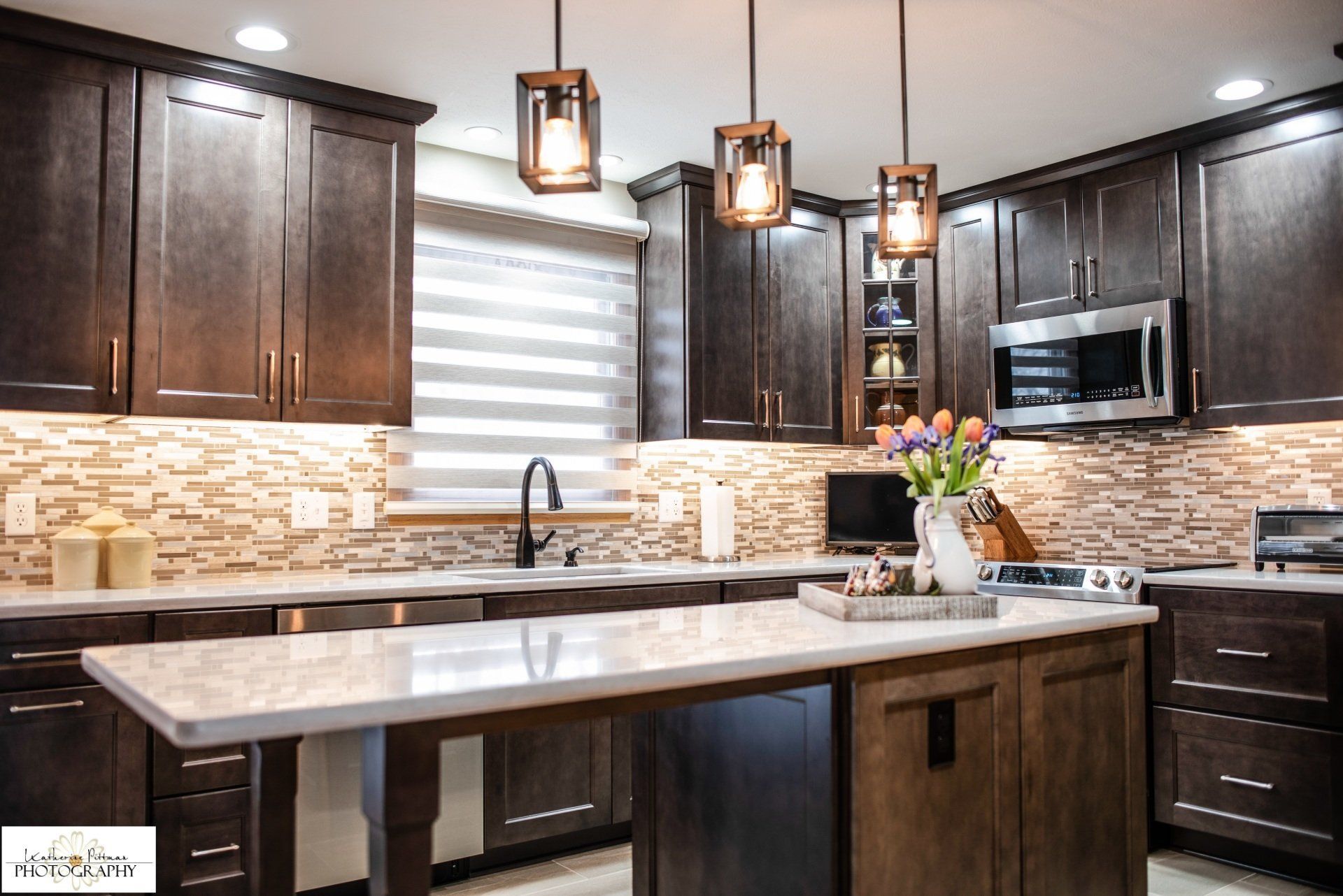 A kitchen with stainless steel appliances and wooden cabinets