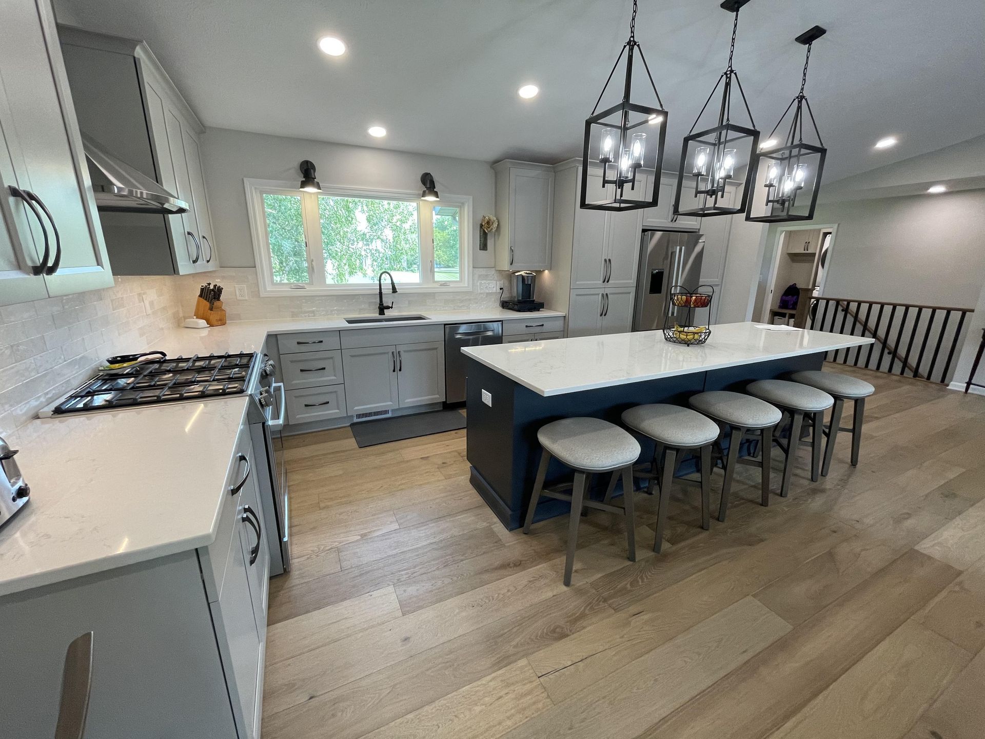 A kitchen with a large island and stools