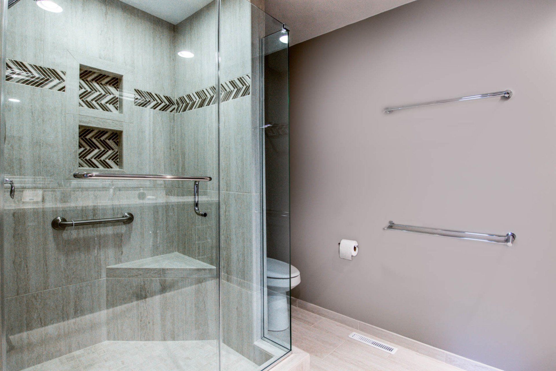 A bathroom with a walk in shower and a toilet.