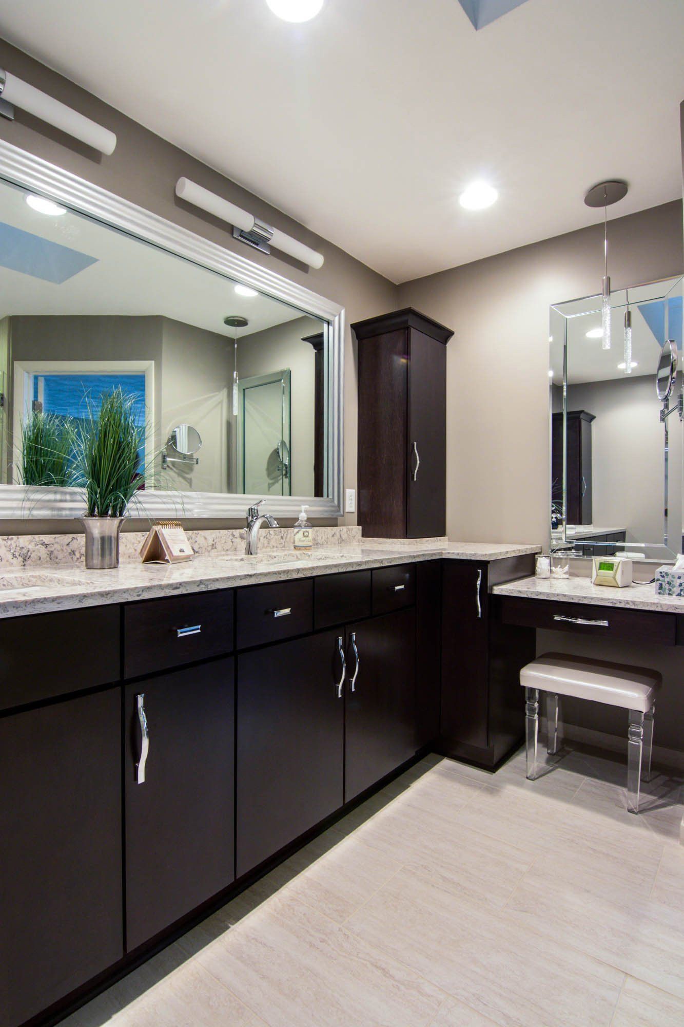 A bathroom with two sinks and a large mirror