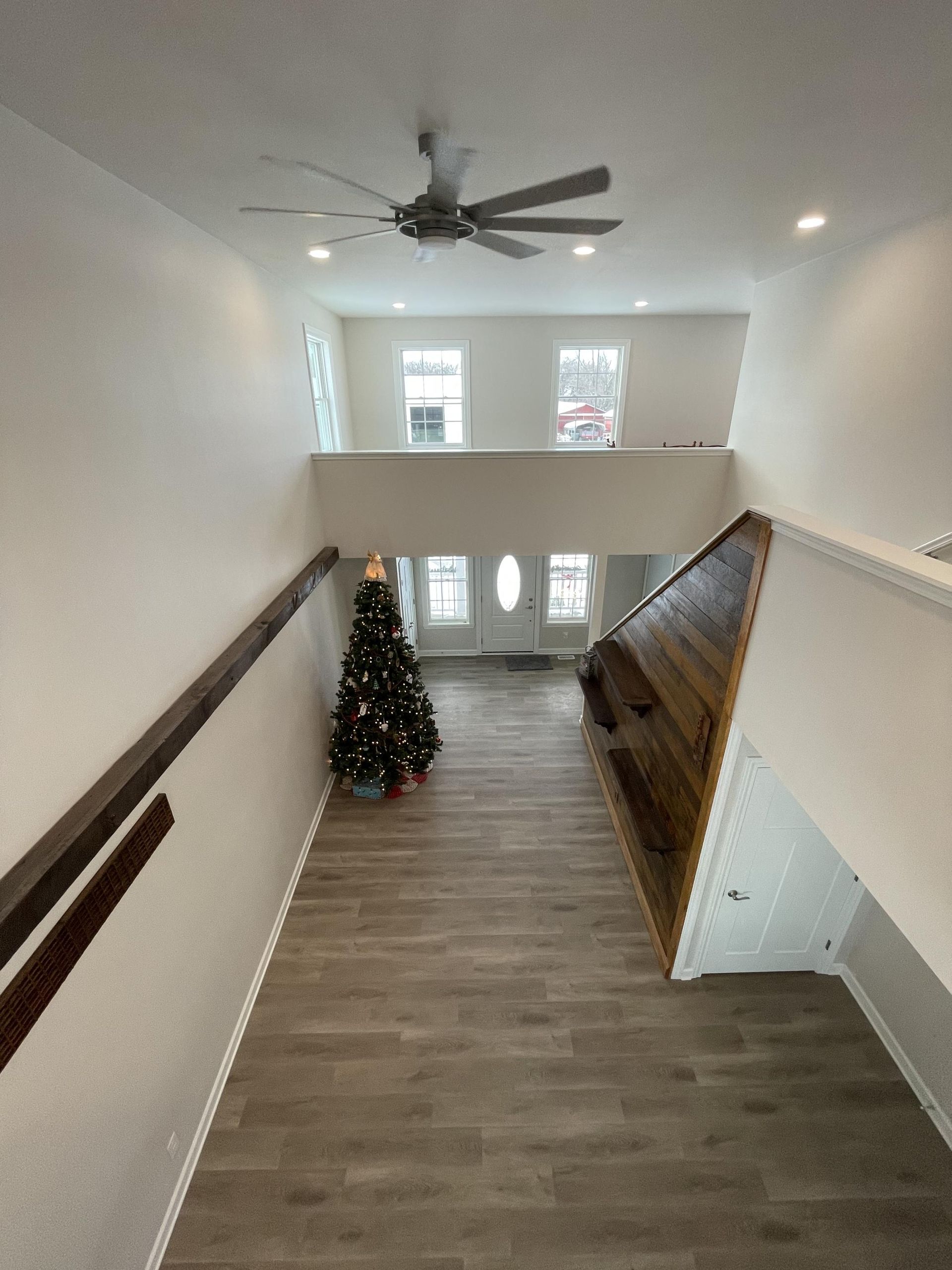 A staircase with a christmas tree in the middle of it
